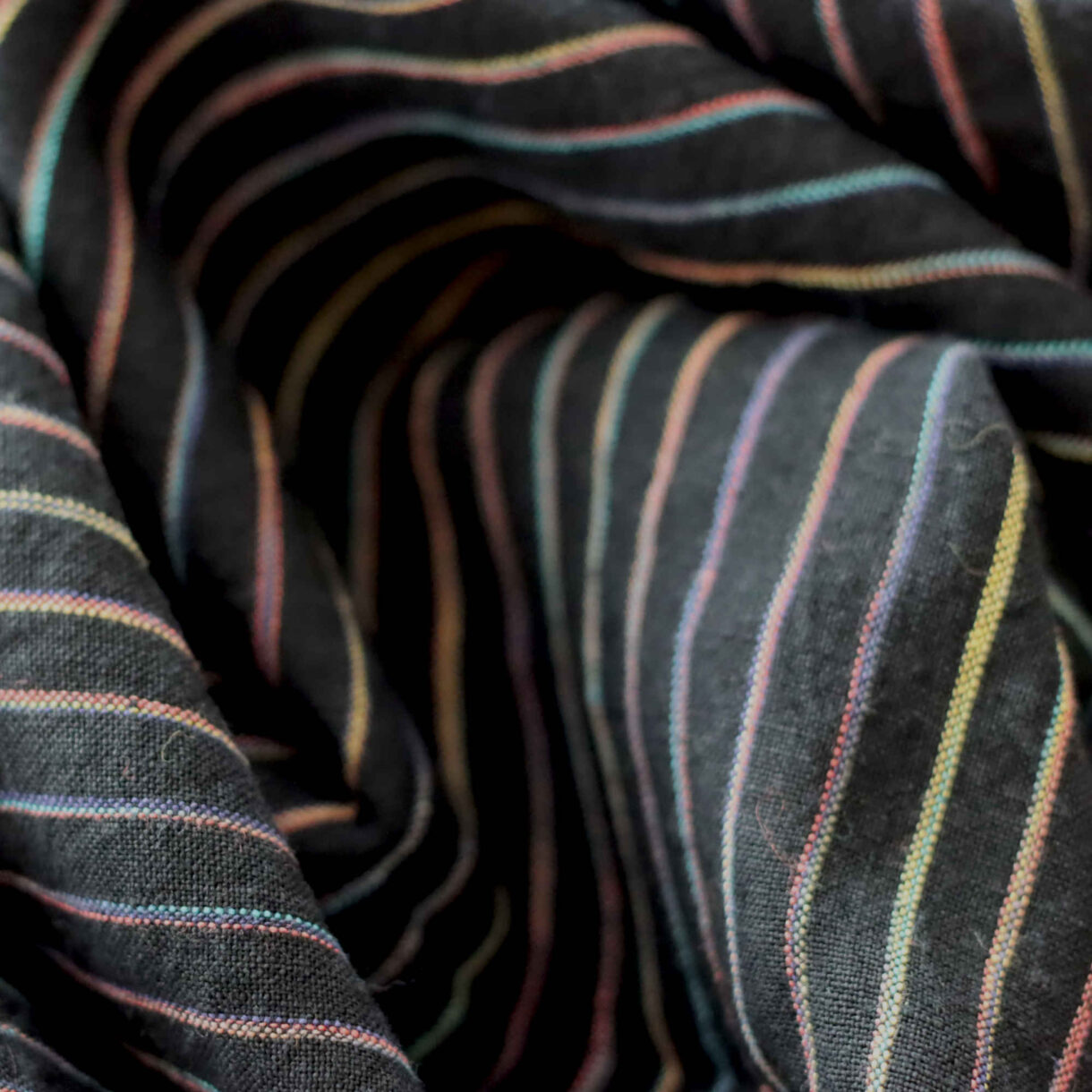 Midnight Rainbow Stripes linen fabric, 160gsm lightweight textile with space-dyed vibrant stripes on dark background