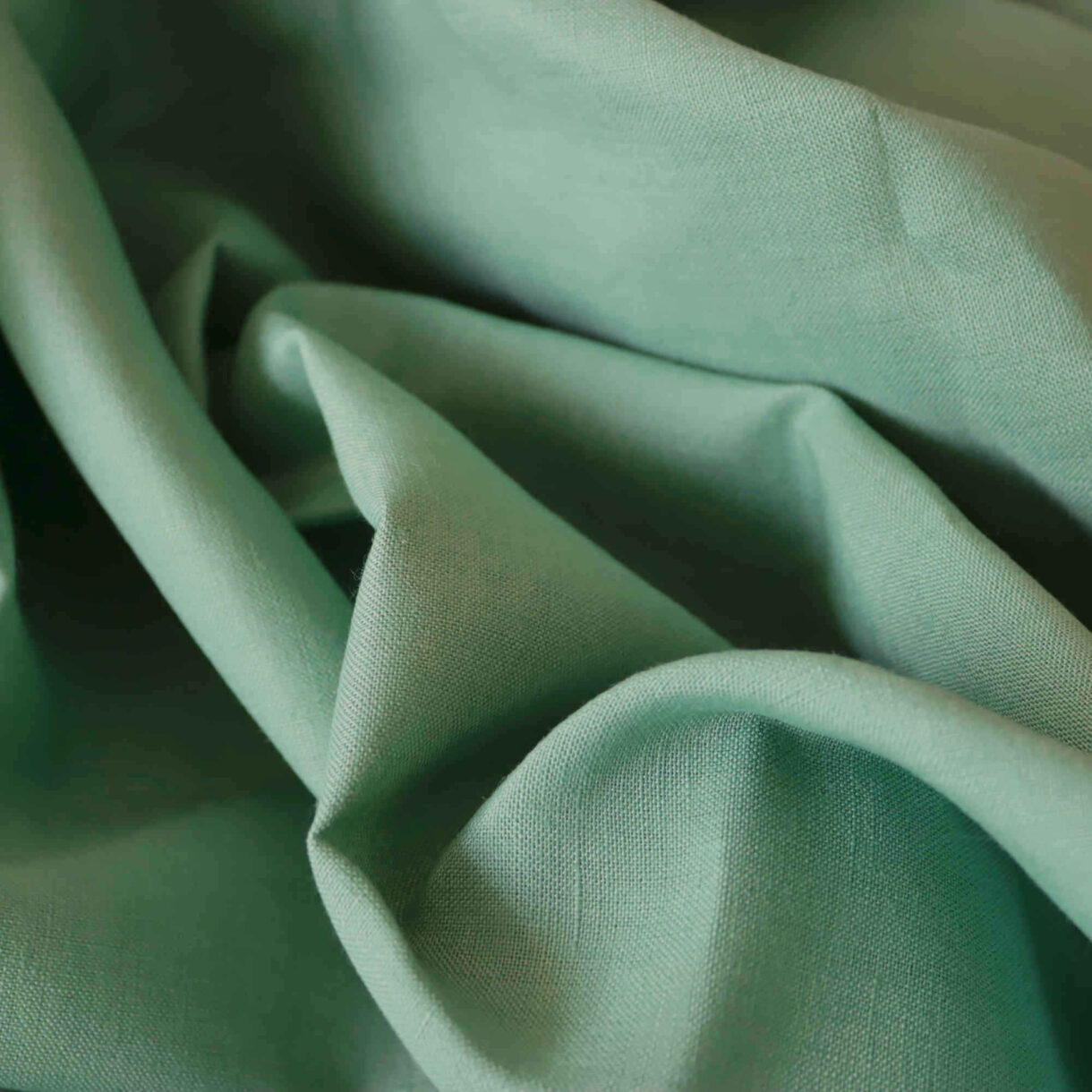 100% Linen Fabric in Malachite Green 200gsm – Close-up showing the breathable, textured weave and rich green color, ideal for garments and home décor.