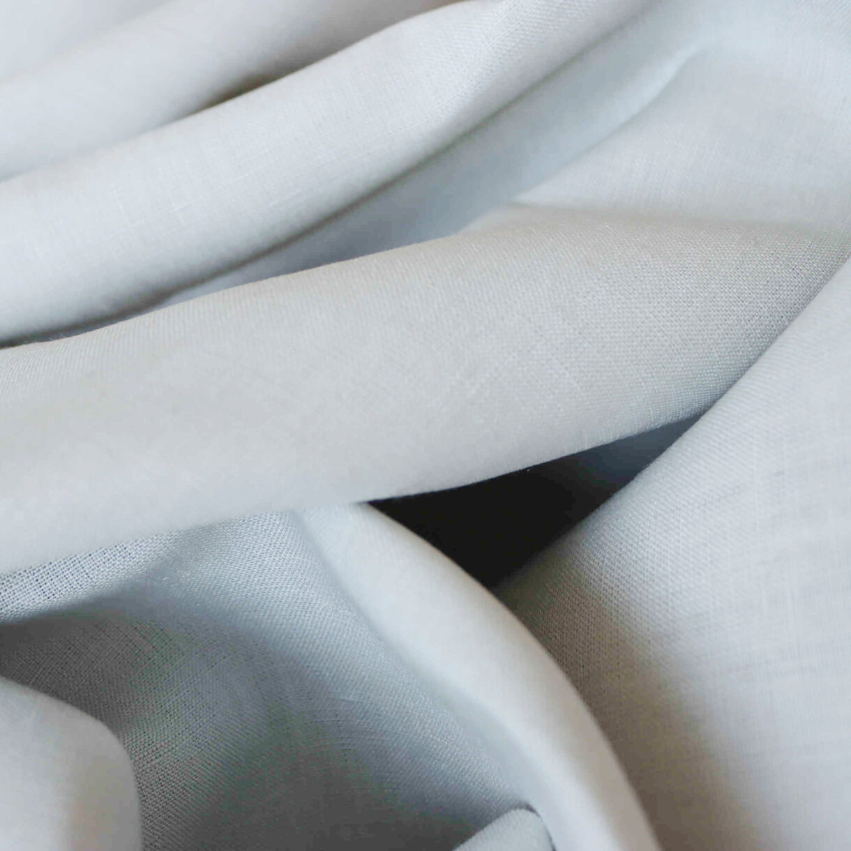 Close-up of 100% Linen Fabric in Mineral Gray, showcasing the soft and breathable texture, perfect for garments and home décor.