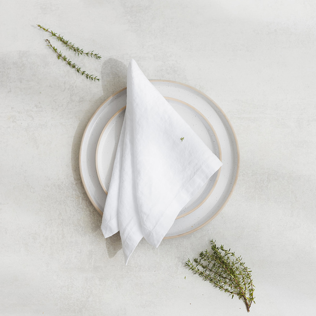Linen napkin  Snow white Set of two 100% linen napkins, neatly folded on a neutral table surface.