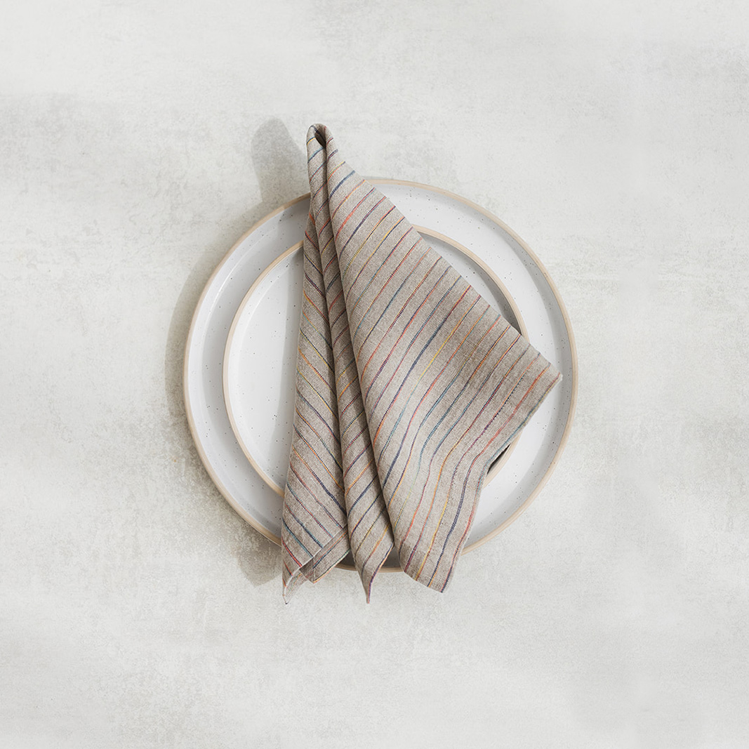 Set of two 100% linen napkins, neatly folded on a neutral table surface.