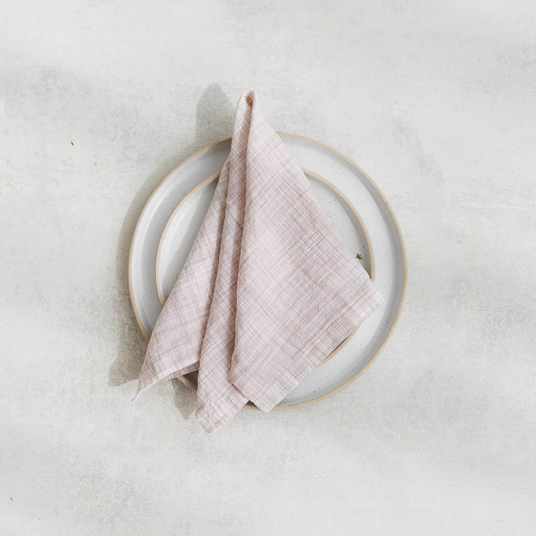 Set of two 100% linen napkins, neatly folded on a neutral table surface.
