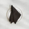 Set of two 100% linen napkins, neatly folded on a neutral table surface.