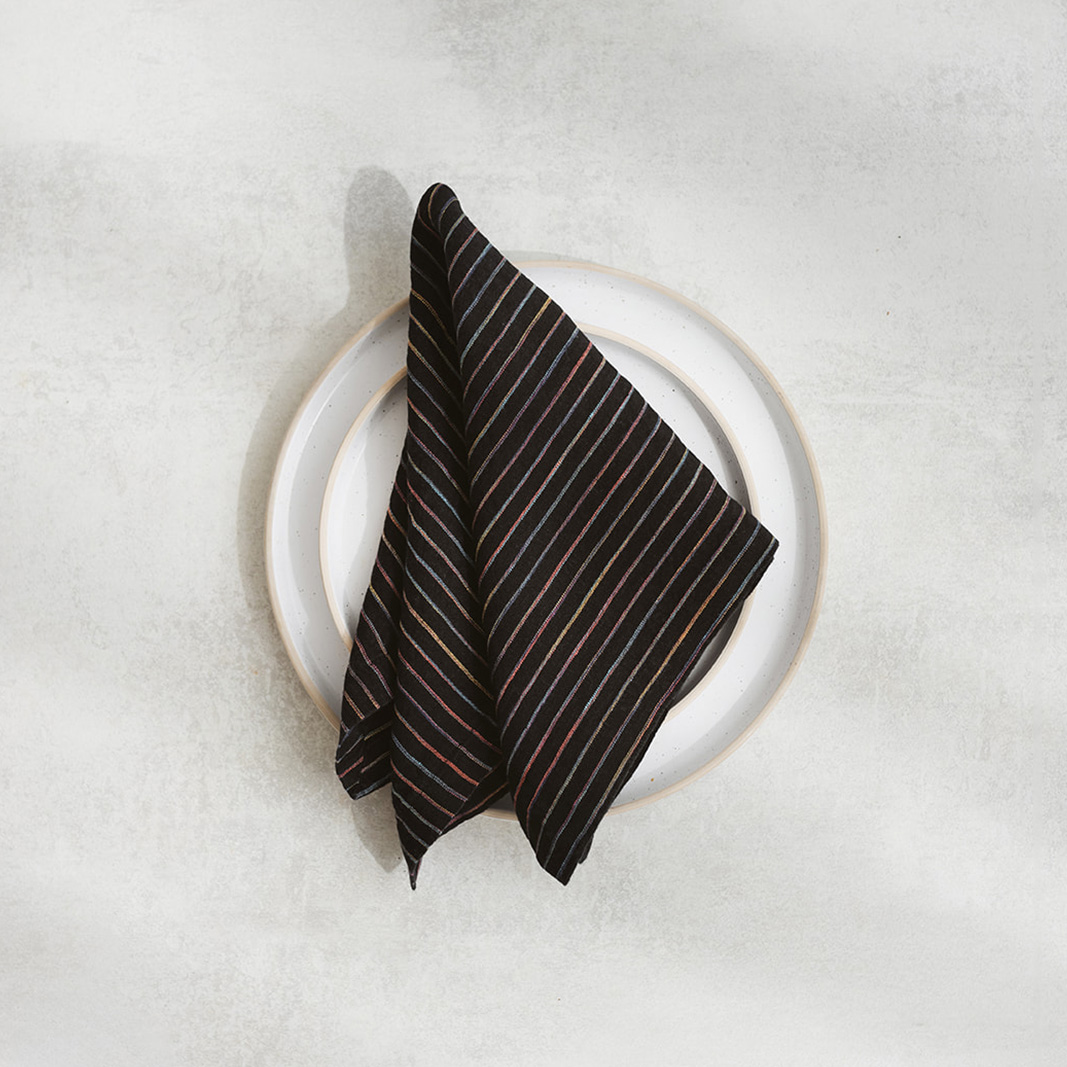 Set of two 100% linen napkins, neatly folded on a neutral table surface.