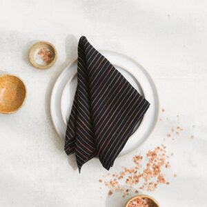 Set of two 100% linen napkins, neatly folded on a neutral table surface.