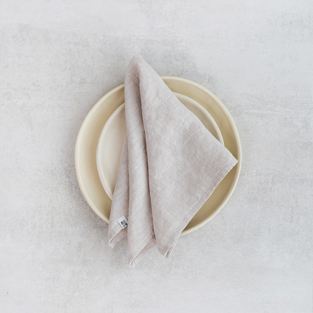 Linen napkin Natural Melange Set of two 100% linen napkins, neatly folded on a neutral table surface.