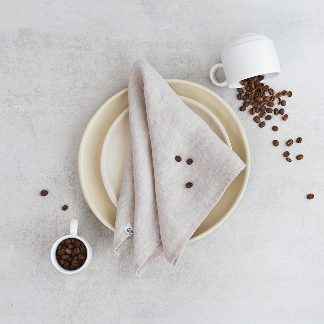 Linen napkin Natural Melange Set of two 100% linen napkins, neatly folded on a neutral table surface.