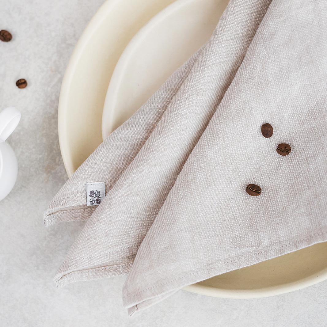 Linen napkin Natural Melange Set of two 100% linen napkins, neatly folded on a neutral table surface.