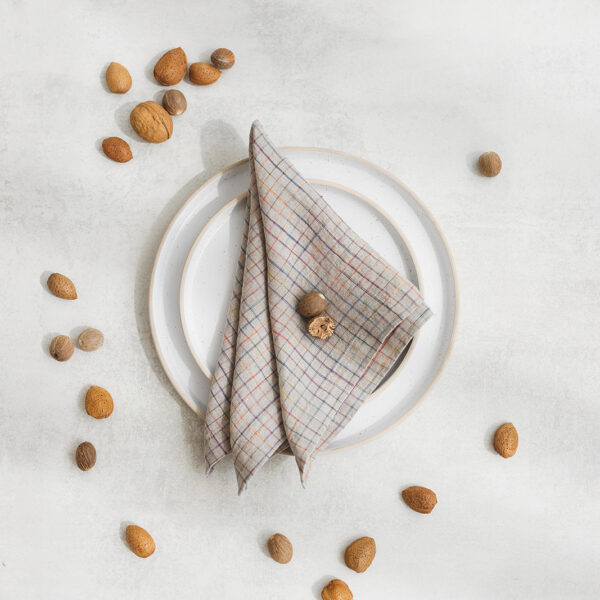 Set of two 100% linen napkins, neatly folded on a neutral table surface.