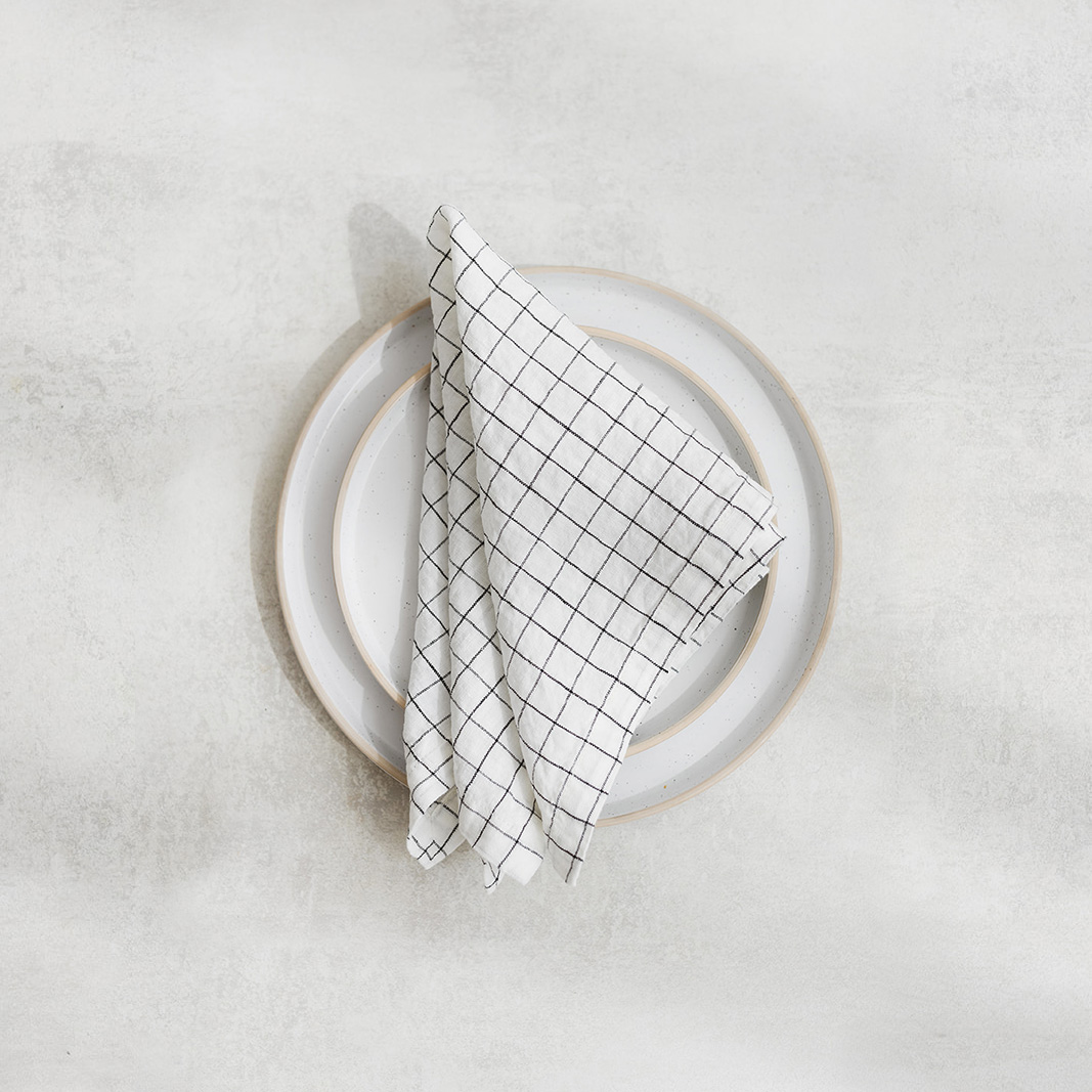 Linen napkin White Grids Set of two 100% linen napkins, neatly folded on a neutral table surface.