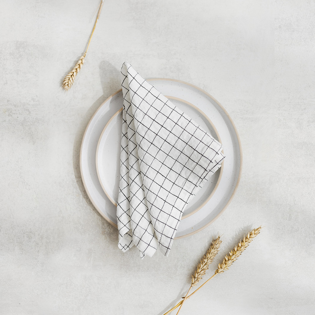 Linen napkin White Grids Set of two 100% linen napkins, neatly folded on a neutral table surface.